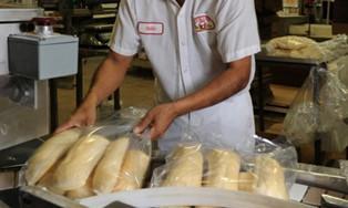 Baker with loaves of bread