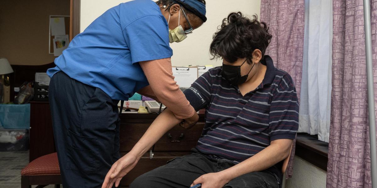 community health nurse takes a clients blood pressure