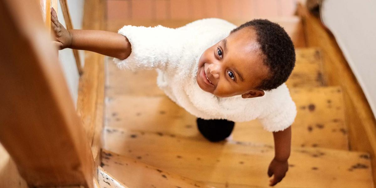 Young Girl Climbing Stairs in Home
