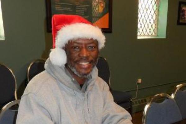 man with santa hat signing papers