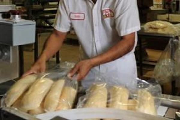 Baker with loaves of bread