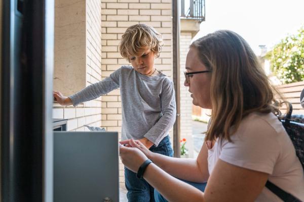 Mother and Child at Apartment Mailbox